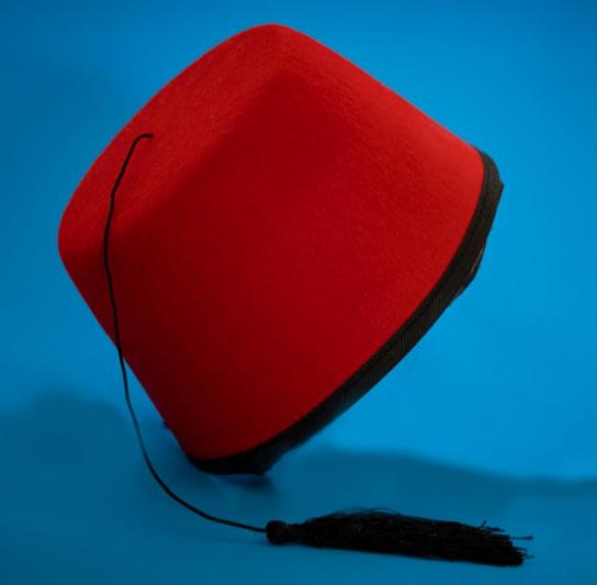 Red fez on blue background.