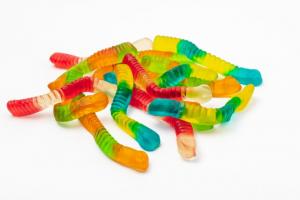 A pile of gummy worms on white.