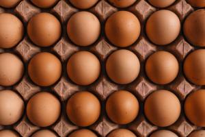 Brown eggs in a crate shot from above.