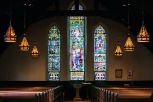 3 panes of stained glass inside of a church.