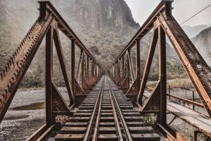 A view down a rusty train bridge.