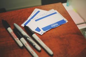 Markers and name stickers on a table.